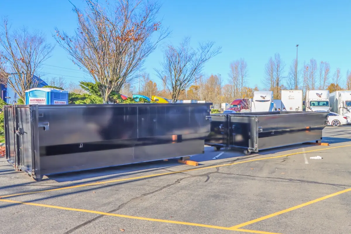 Professional dumpster rental service with roll-off container on residential driveway in Kankakee